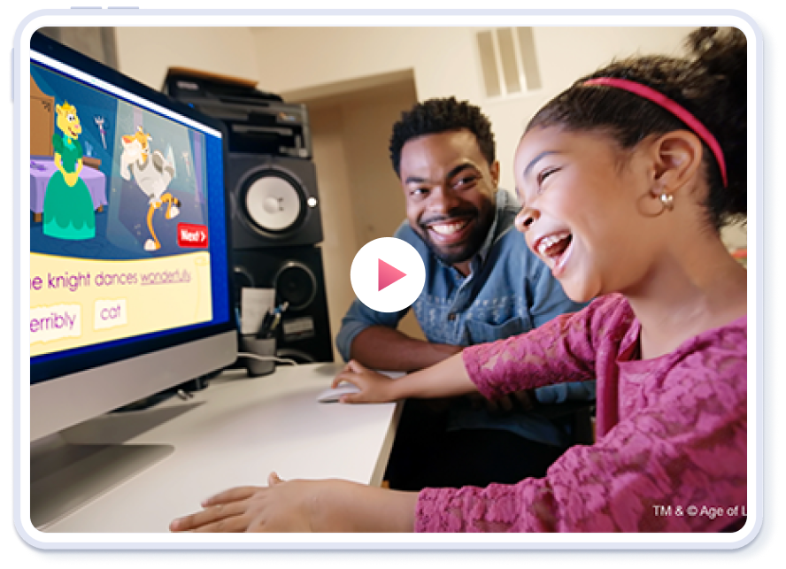 A girl playing abcmouse on a computer with her dad.