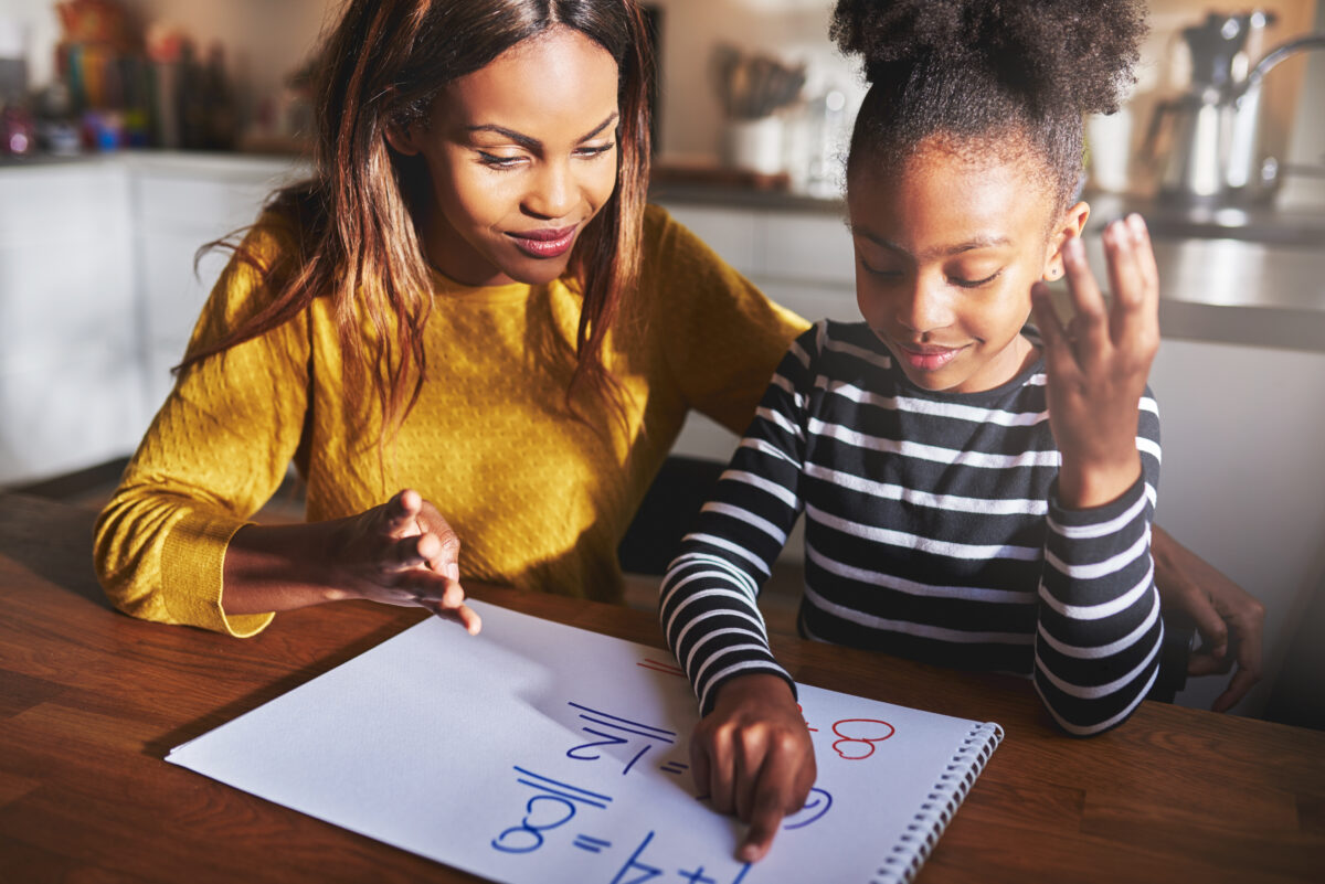 Mom and daughter doing math together.