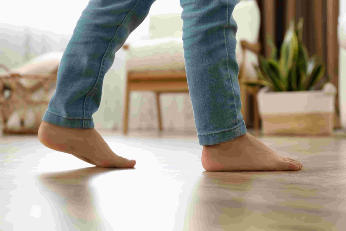 Childs feet walking across the floor. 