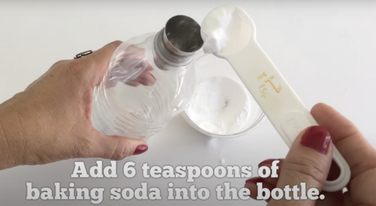 Baking soda being added to a plastic bottle as part of a Science Experiment. 