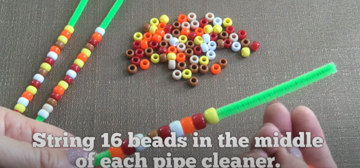 Stringing bead onto rows of pipe cleaners to do a fun Thanksgiving craft. 