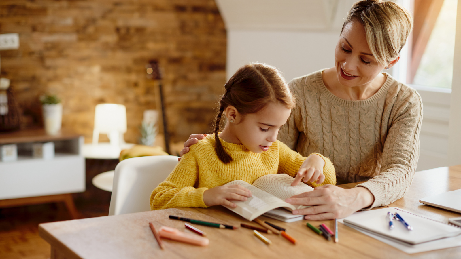 Mother and daughter working on school work together. 