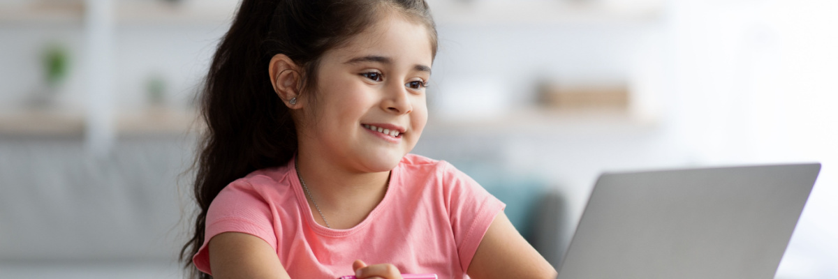 A young girl playing ABCmouse on a computer. 