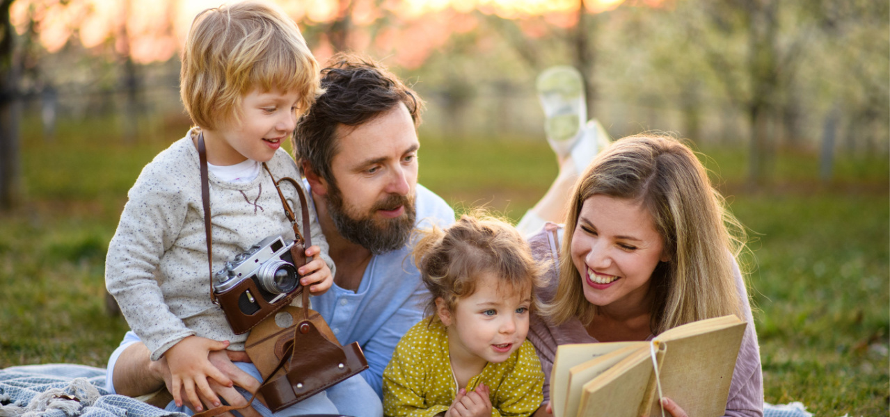 A family enjoying reading together out in nature. 