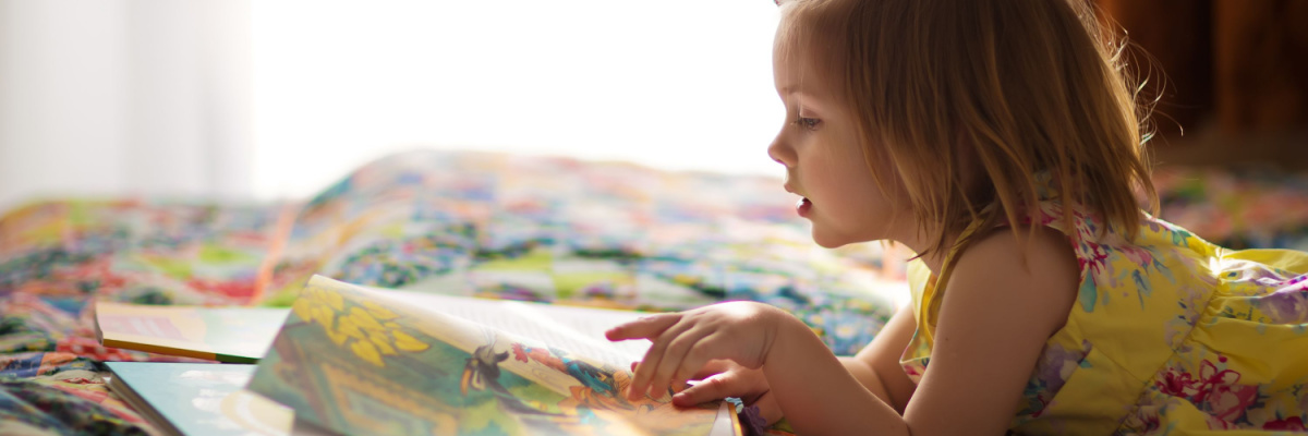 Child reading from a book. 