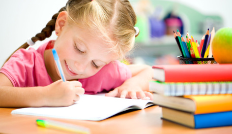 Second grader writing in a journal. 