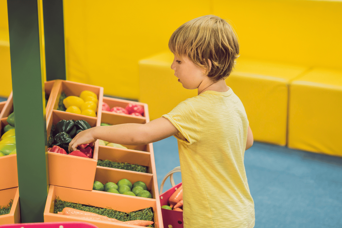 Child sorting fruits and veggies. 