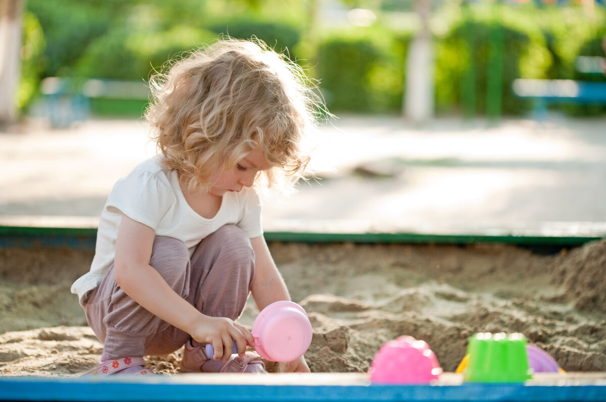 Child playing in the sand. 