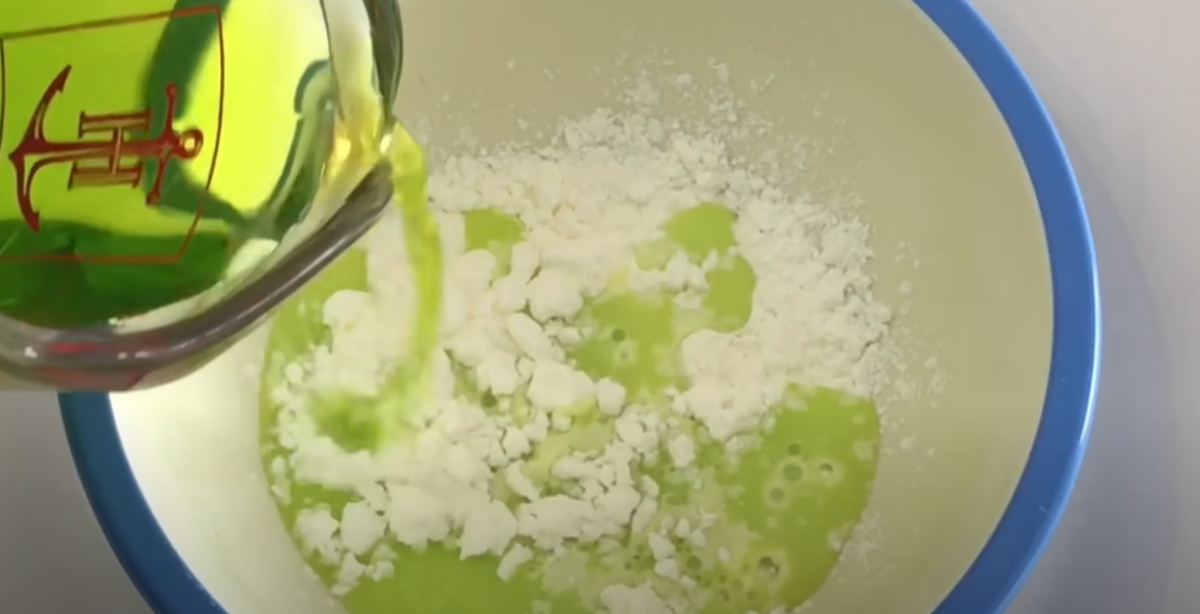 Combining bright green water with corn starch in a bowl. 