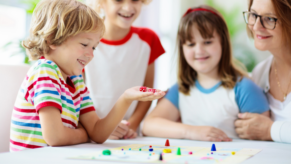 Young children playing a fun board game together. 