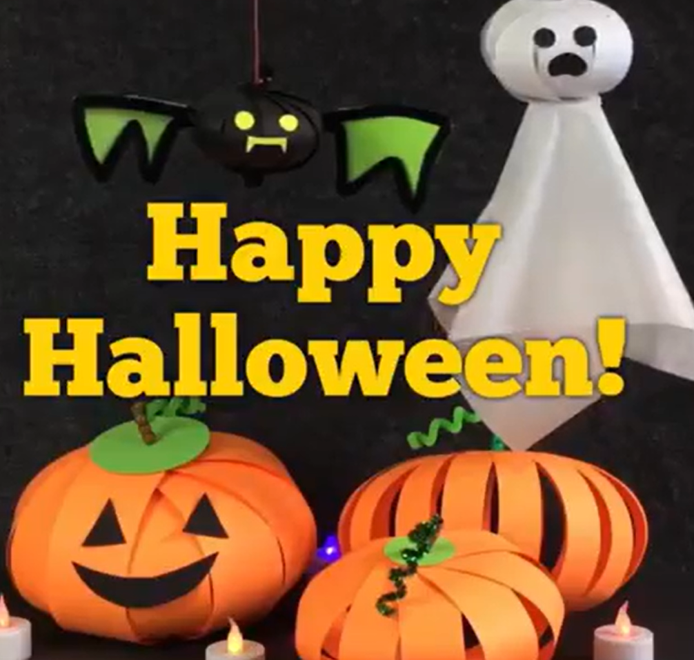 Happy Halloween fun construction paper pumpkin craft with a ghost and a bat in the background. 