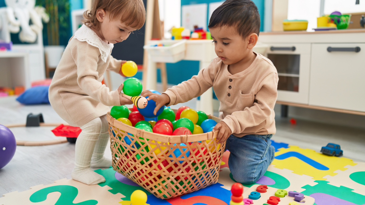 Children playing with colorful balls. 