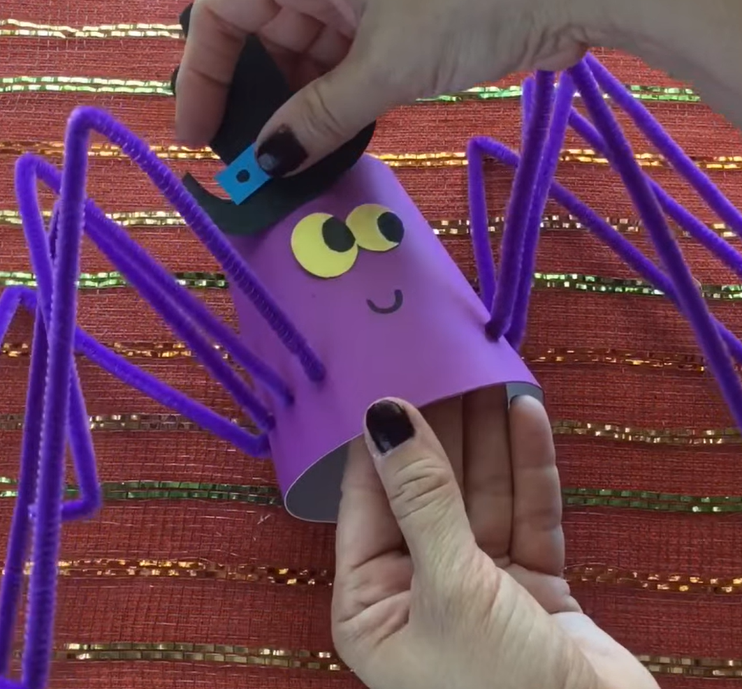 Creating a purple spider with pipe cleaner legs and a cute hat. 