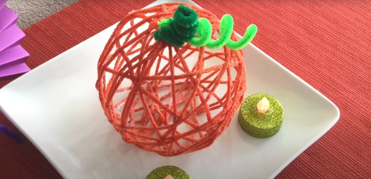 Displaying a fun pumpkin yarn craft for the fall holidays. 