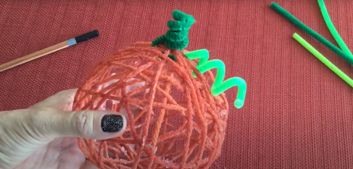 A twisty leaf on a pumpkin yarn craft. 