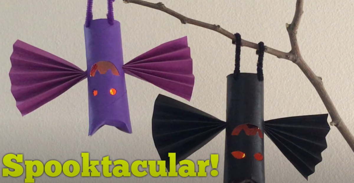 Display of two Halloween bats made from cardboard tubes and paper. 