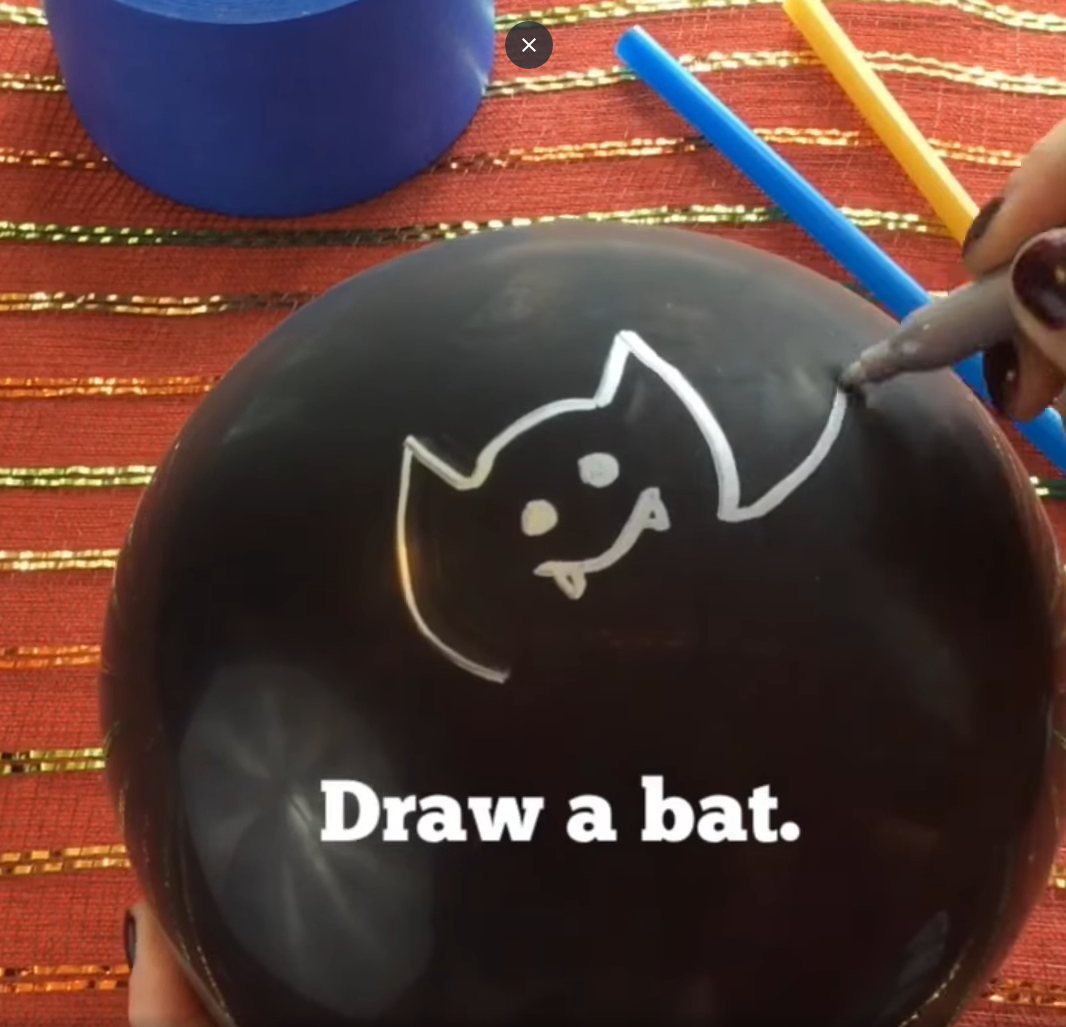 Draw a bat on the balloon that has bee blown up. 