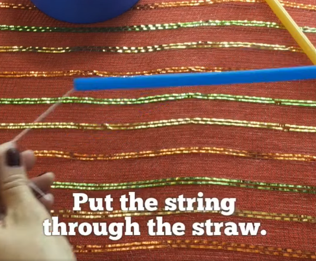 Put the string through a straw. 