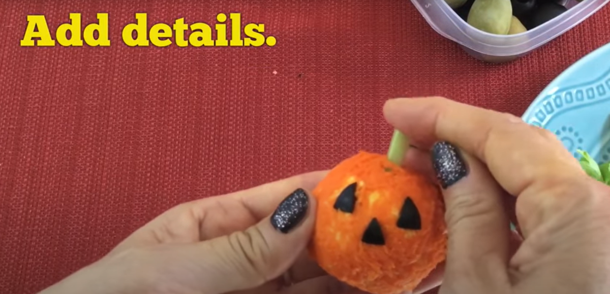 Adding details to the cheese pumpkin treat