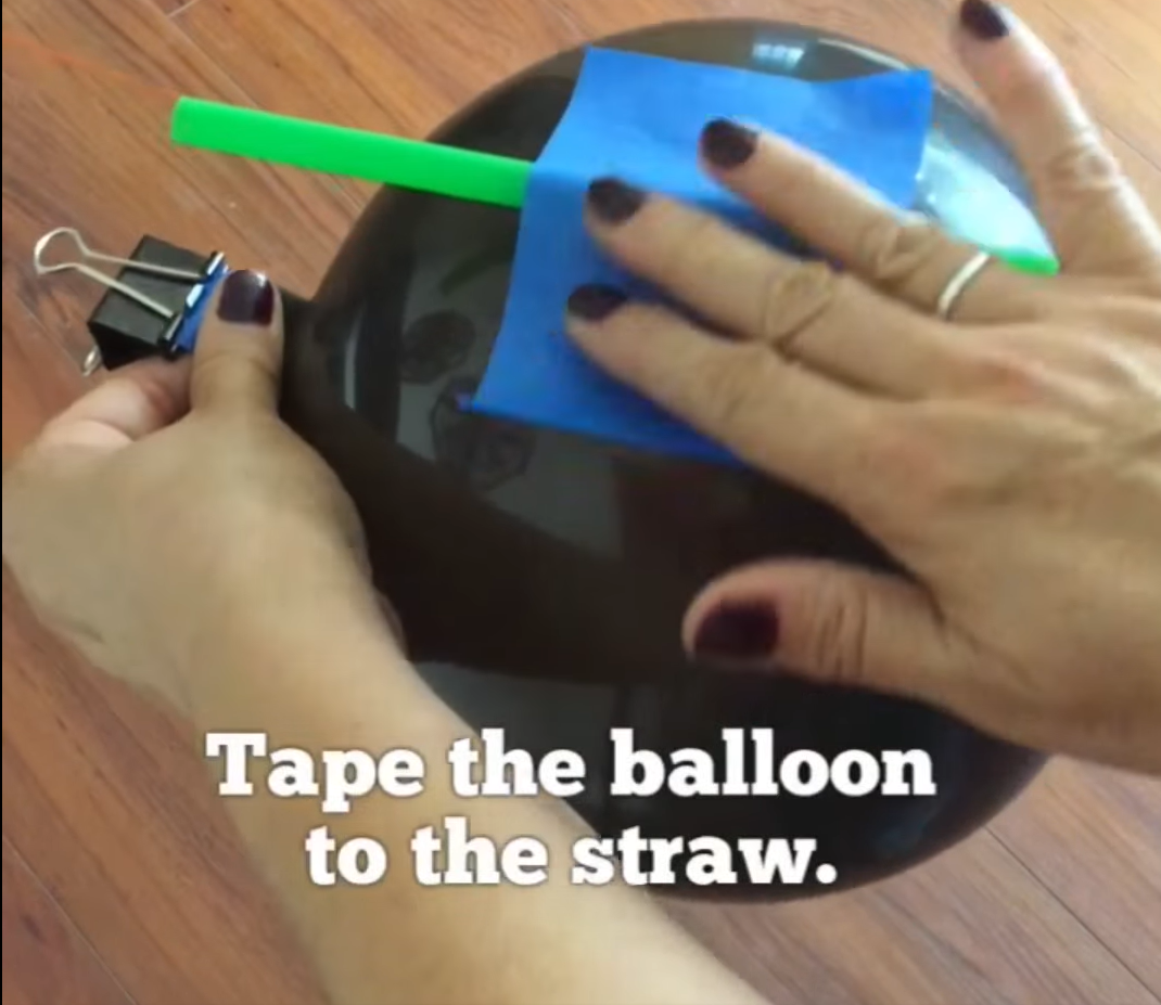 Tape the straw to the balloon. 