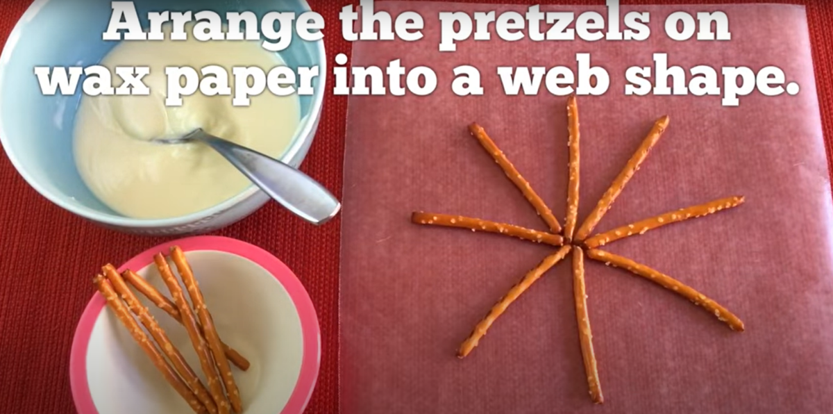 Small pretzels arranged in a web shape with white chocolate. 