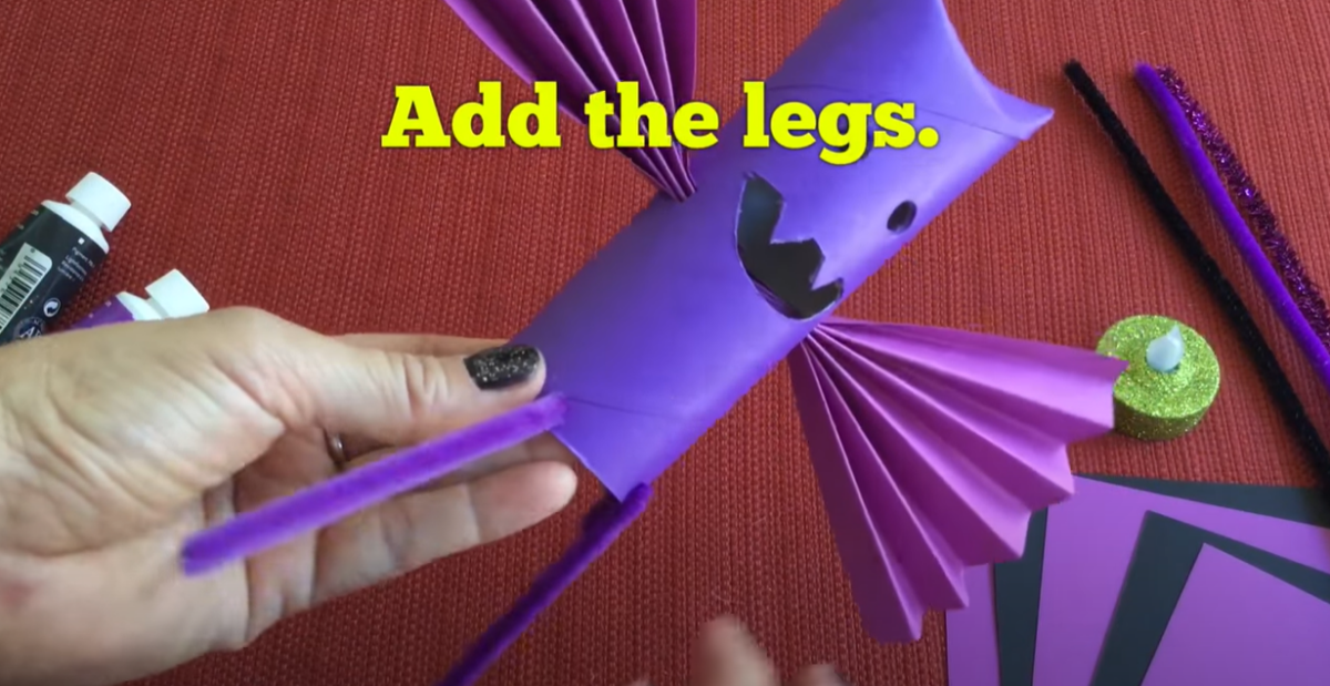 Adding pipe cleaner legs to the bat craft. 