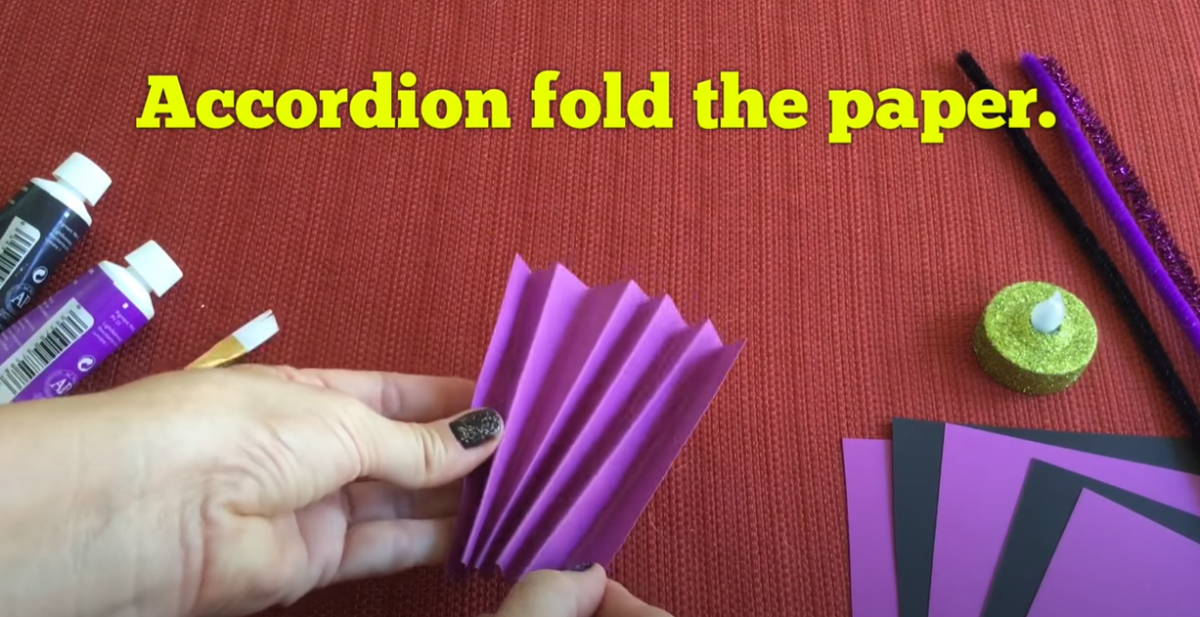 Accordion folding paper for a Halloween bat craft. 