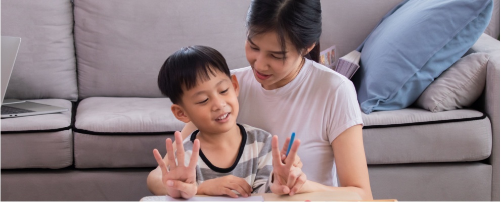 A mother and son counting and working on learning subitizing skills. 