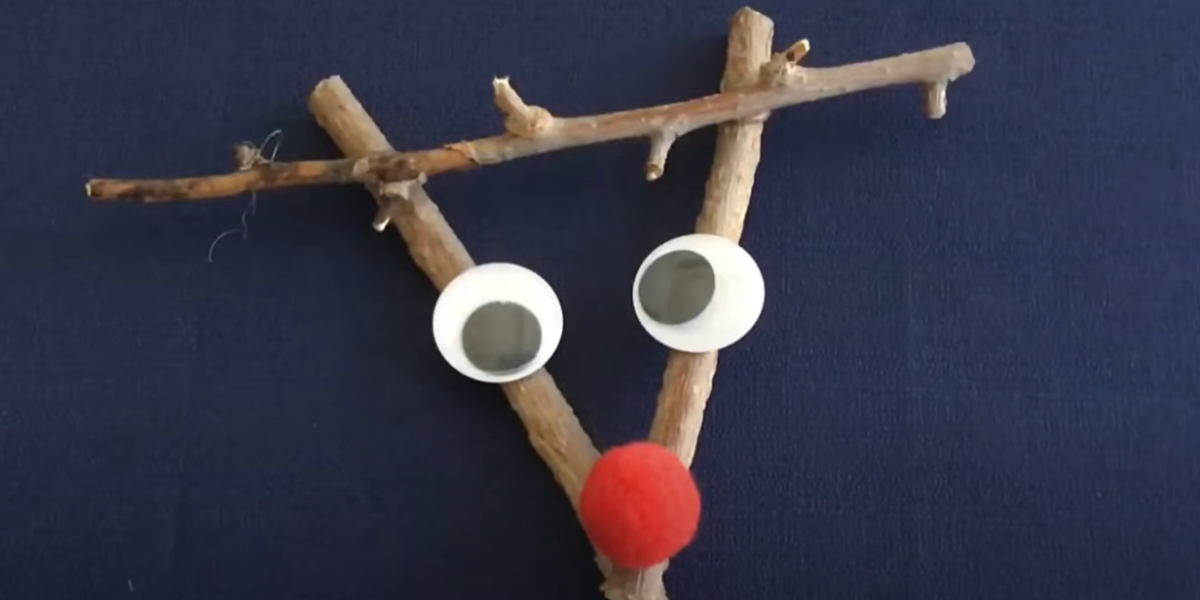 A homemade stick ornament of Rudolph the red nose reindeer. 