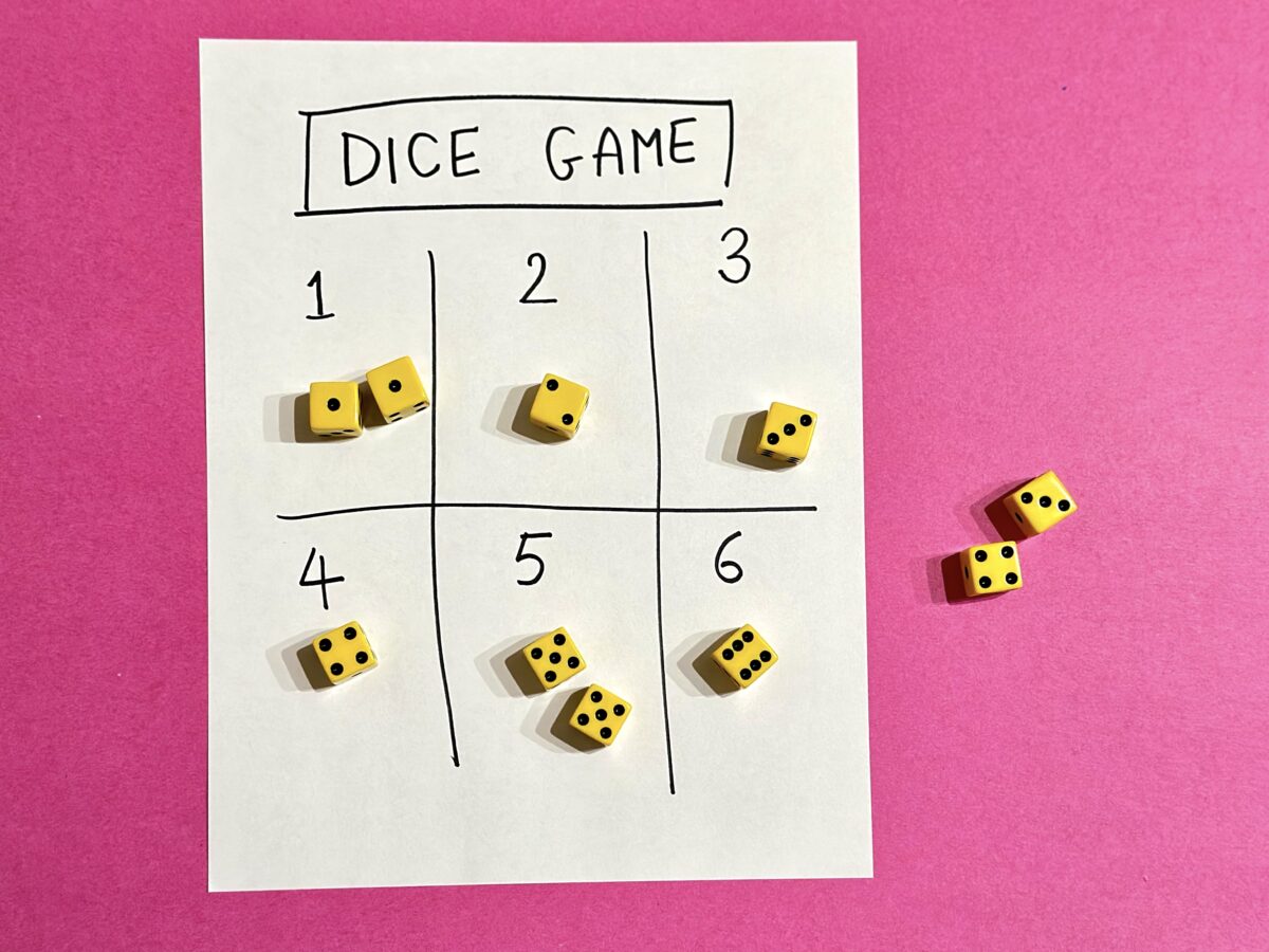 A piece of paper with numbers 1-6 and dice of different numbers on it. 