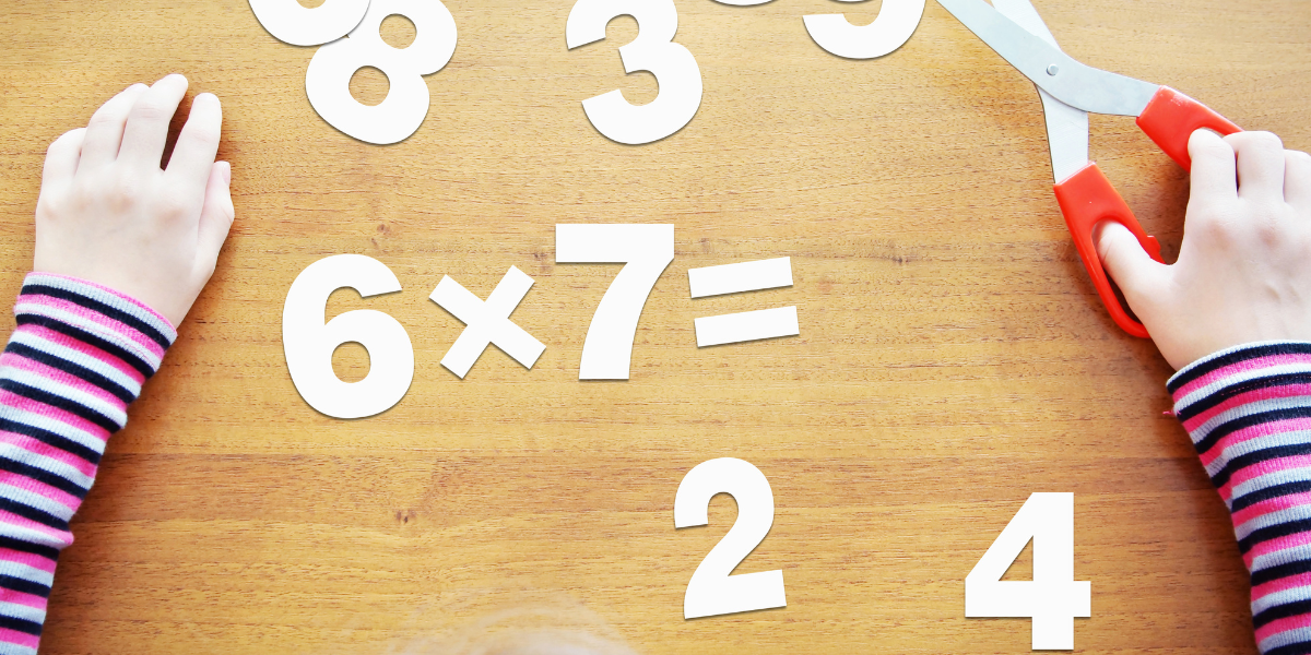 Large white numbers making up multiplication problems on a desk.