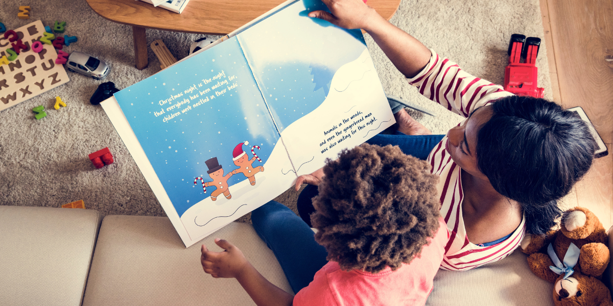 Mother and child reading a picture book together. 