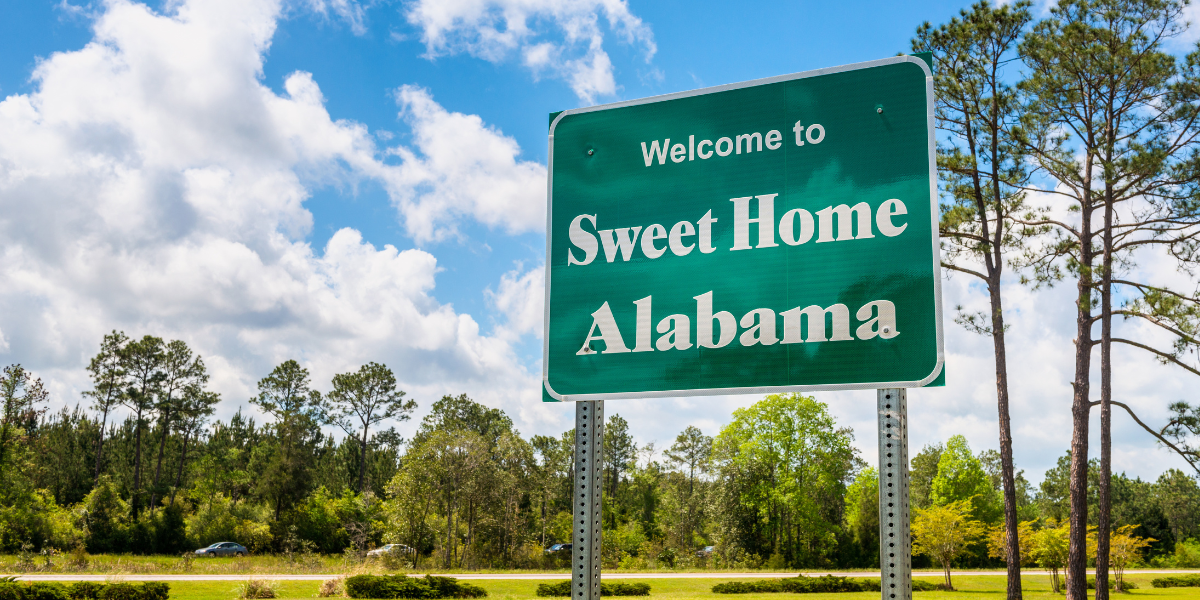 A road sign that says sweet home Alabama.