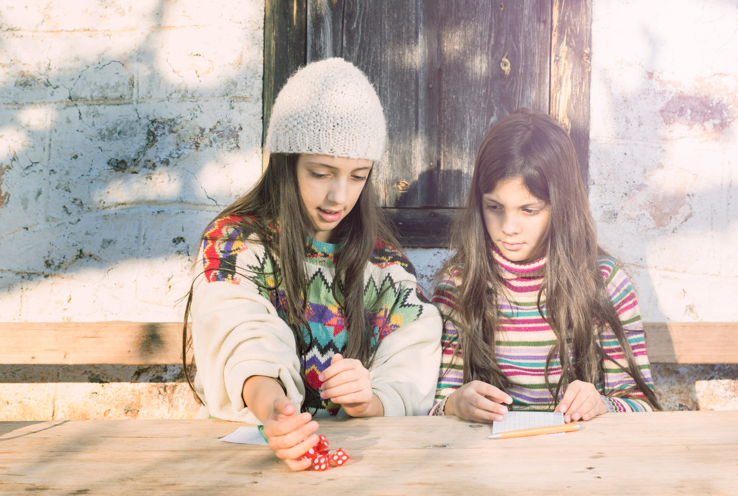 Children rolling dice. 