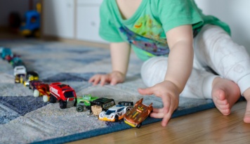 Child playing with toy cars. 