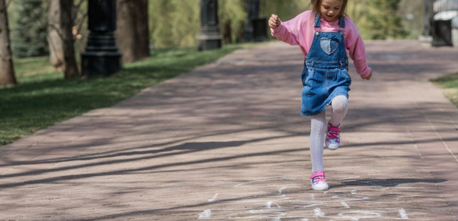 A child playing hopscotch. 