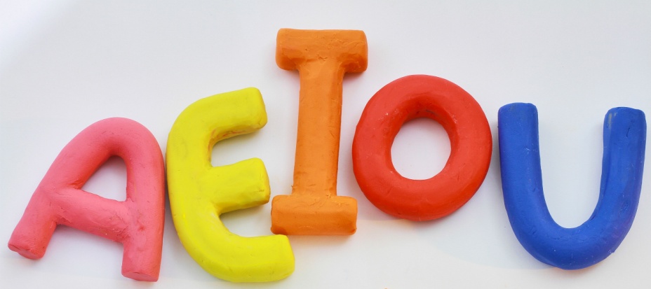 Colorful vowel letters a e i o u made from clay. 