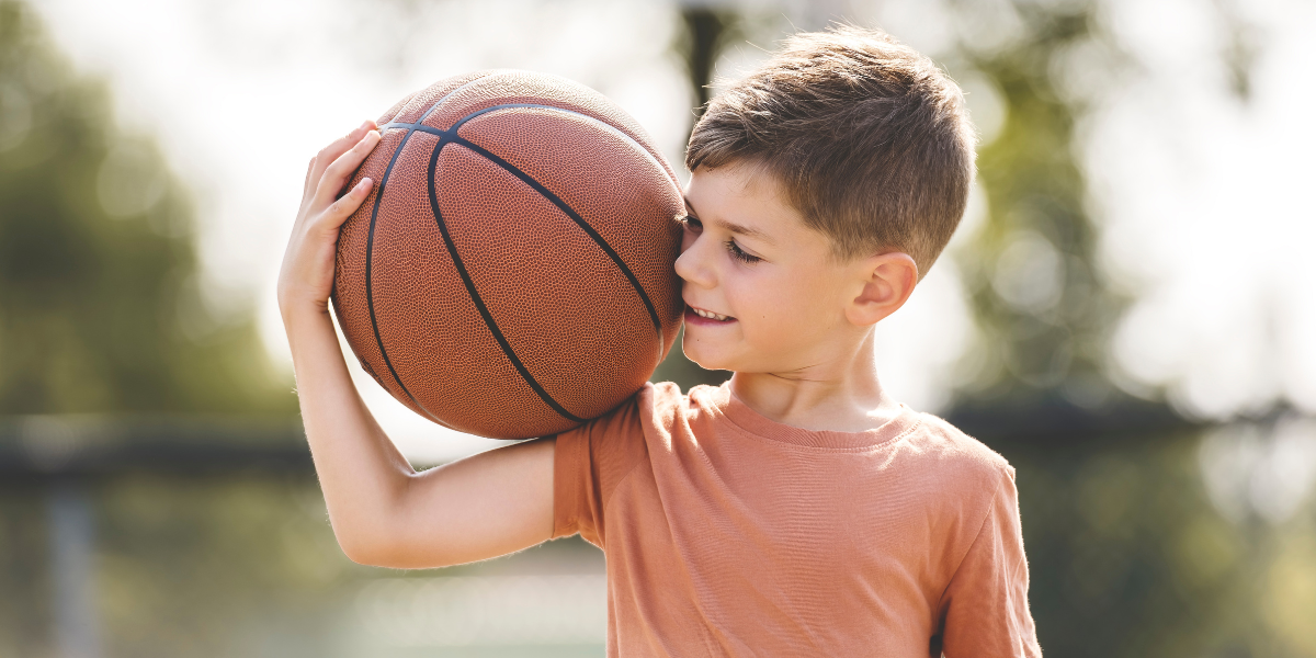 Boy holding a basketball. 