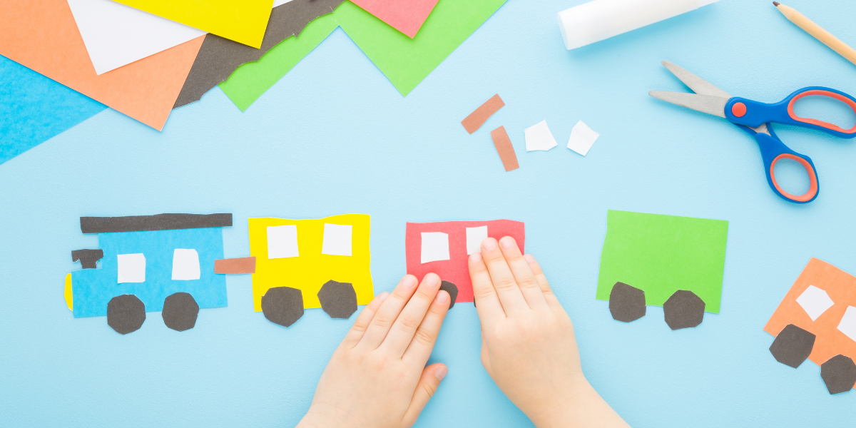 Colorful construction paper trains on a blue background. 