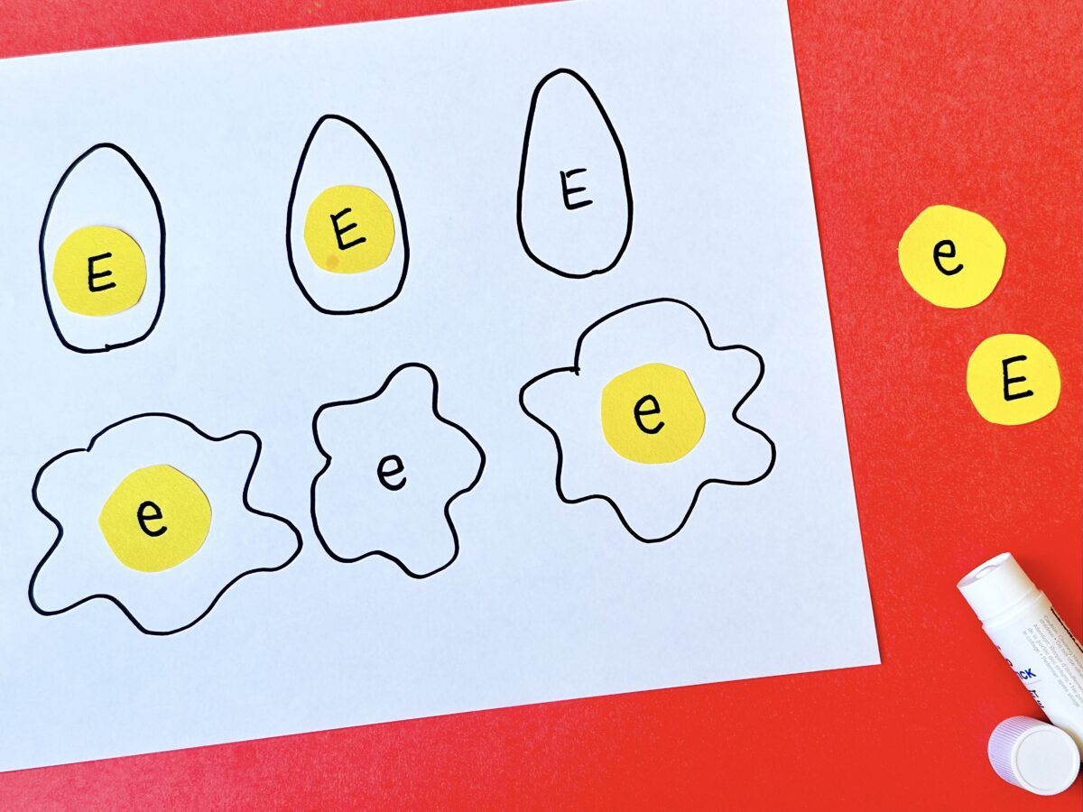 E is for eggs egg shapes on a paper with large and small letter e's in yellow. 