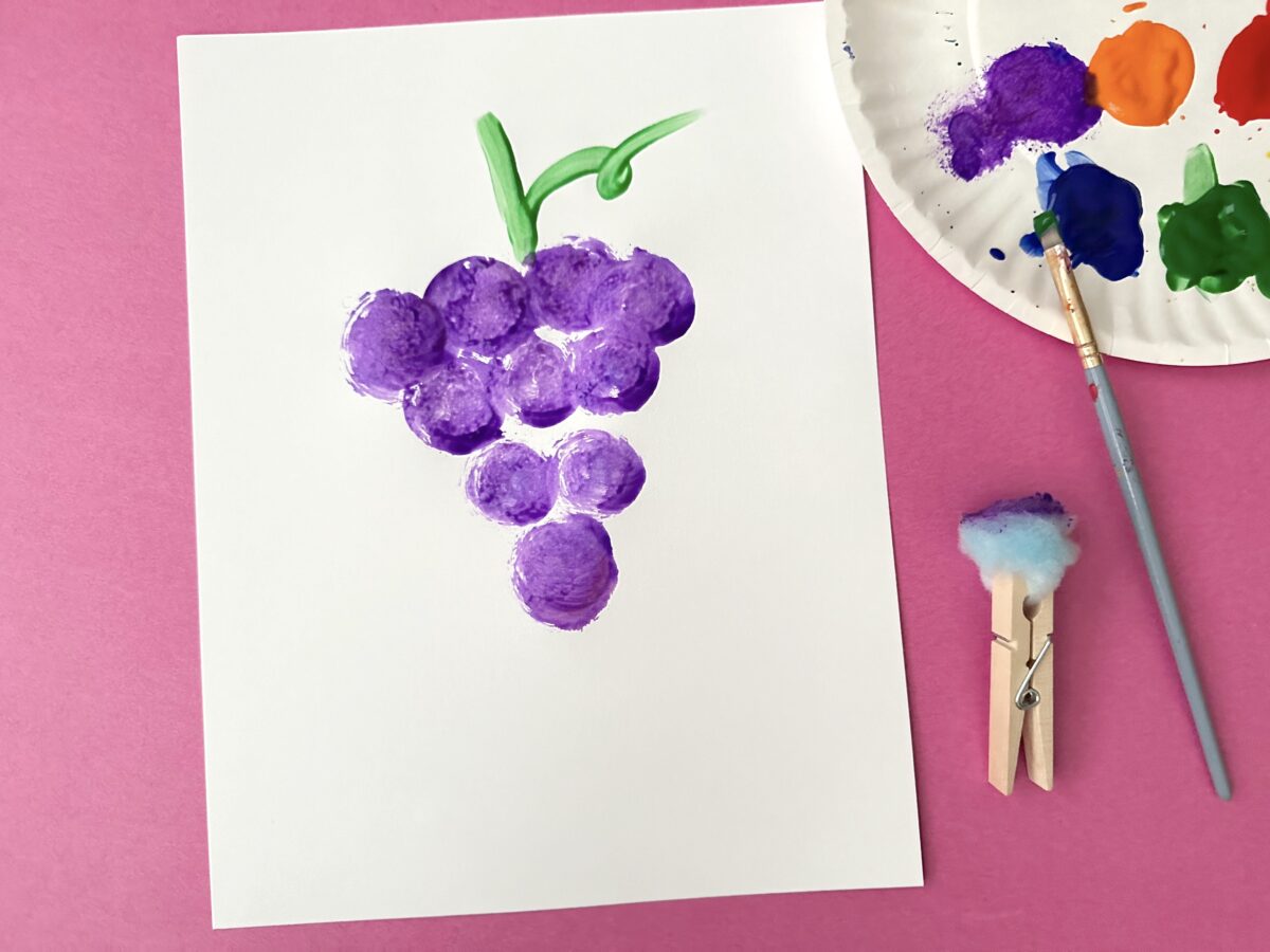 Grapes painted on a white piece of paper with a clothespin and a cotton ball. Letter g craft from ABCmouse.com