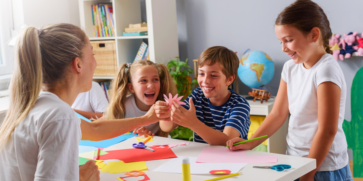 Kids having some fun and laughing together while doing a craft together. 