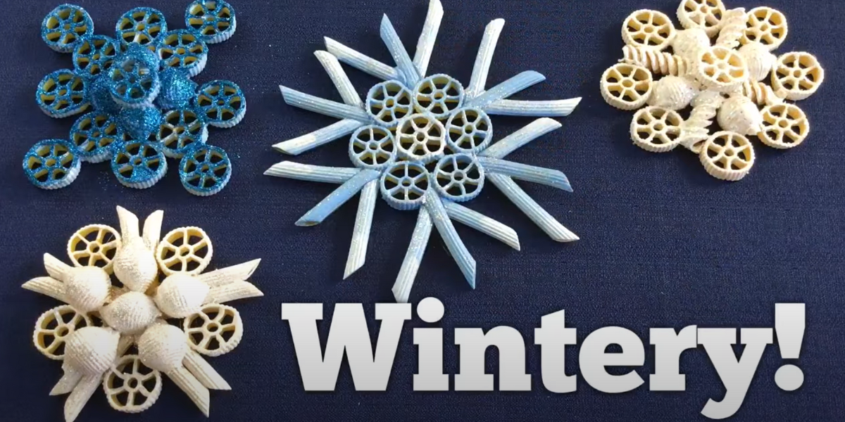 The word wintery surrounded by different types of DIY pasta snowflake Christmas tree ornaments. 