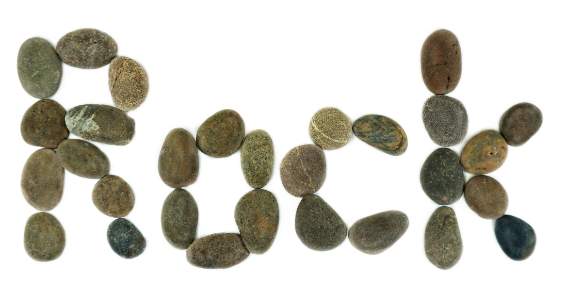 The word rock spelled out in small rocks. 