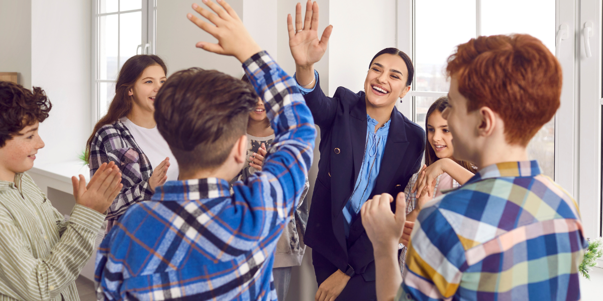 Students high fiving each other. 