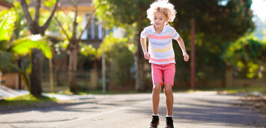 Child jumping up and down out side. 