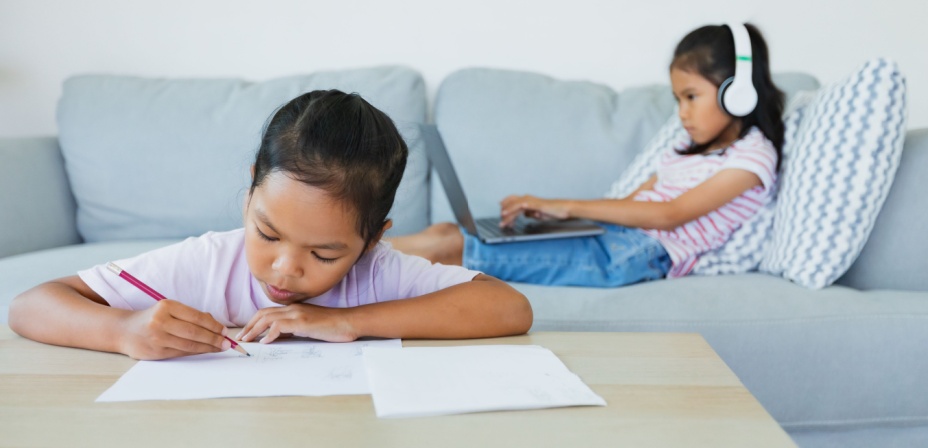 Children doing school work at home. 