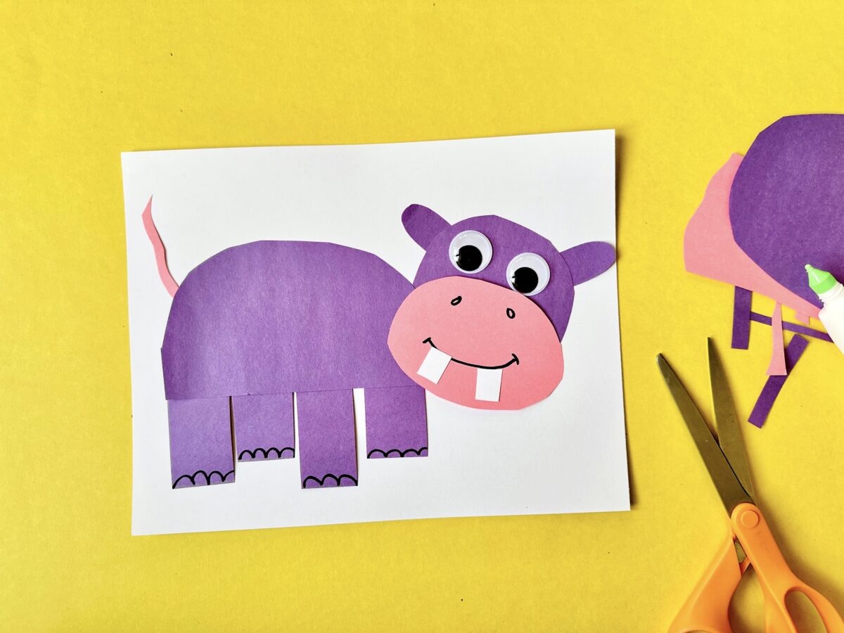 A purple construction paper hippo on a white background. Fun craft for kids to learn the letter h. 