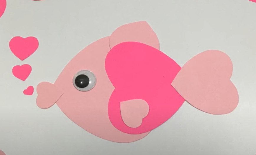 A cute valentines day fish craft made from cut paper hearts. 