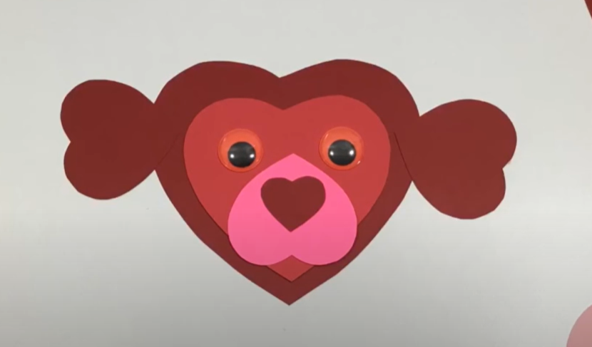 A cute valentines day dog craft made from cut paper hearts. 